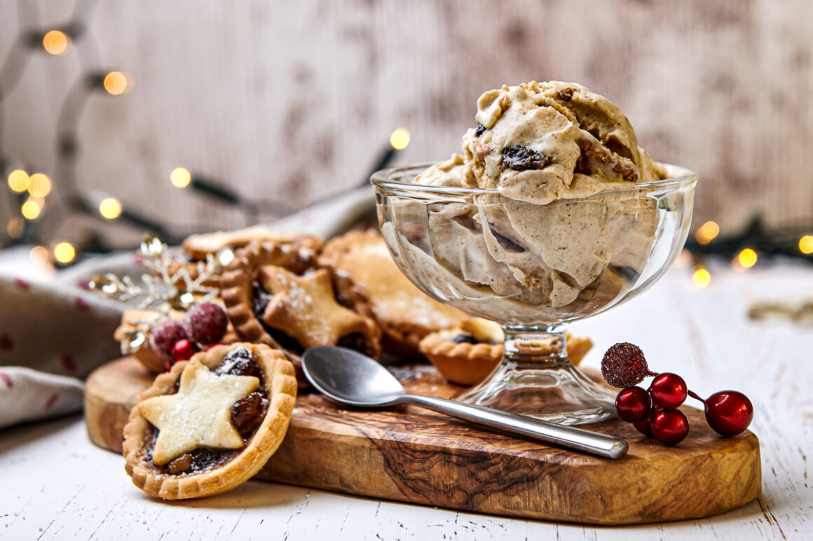 festive themed image of mince pie ice cream with mince pies nearby alongside xmas decorations. shot by professional food photographer for coeliac uk