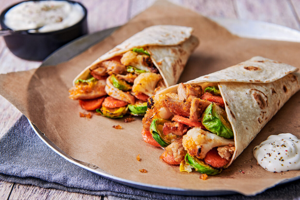 sid eon image showing the contents of two turkey and veg filled wraps, with a pot of sauce off to the side. shot by professional food photographer for santa maria