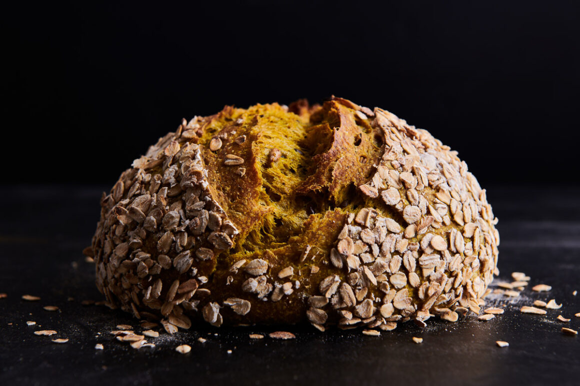 dark and moody shot of sourdough loaf shot for foodbod sourdough and page street publishing by professional food photographer.